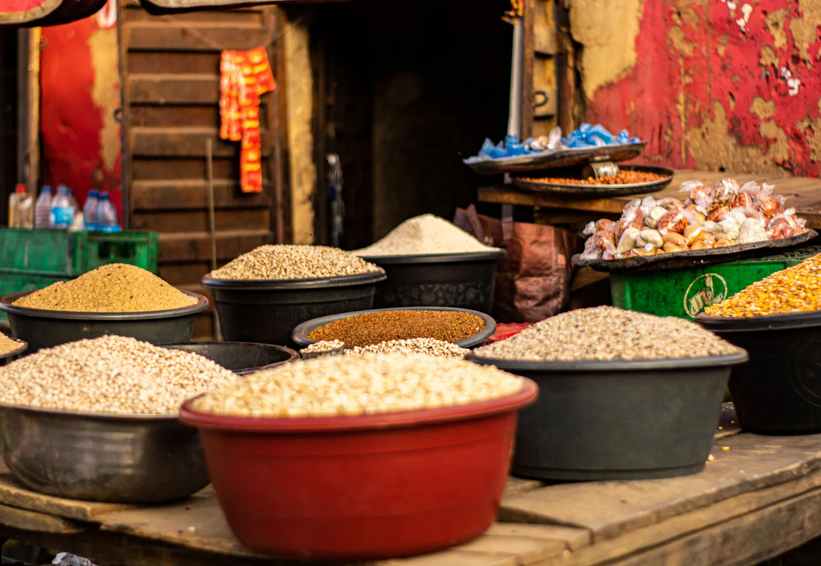Basins of beans, maize, millet and other grains heaped on a market stall
